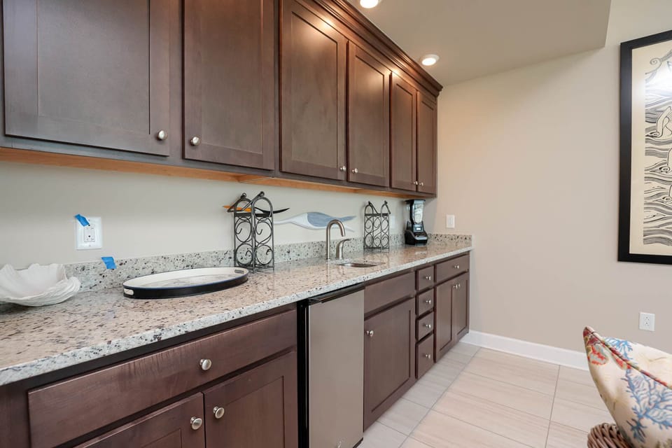 Unwind with a refreshing drink from the wet bar, enjoying lighthearted moments in this welcoming space