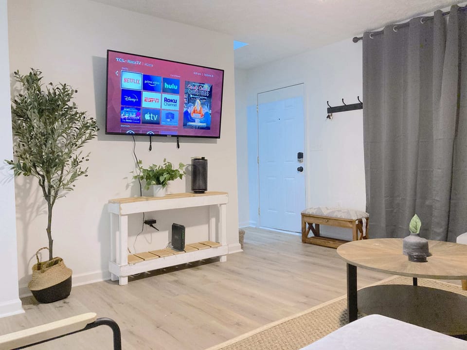 Living room with a 55 inch TV including Netflix, Hulu, Disney+ and ESPN+