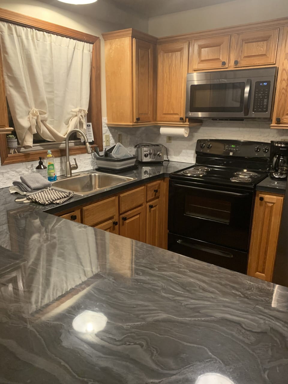 Kitchen (main level) stocked with dishes, utensils, pots and pans
