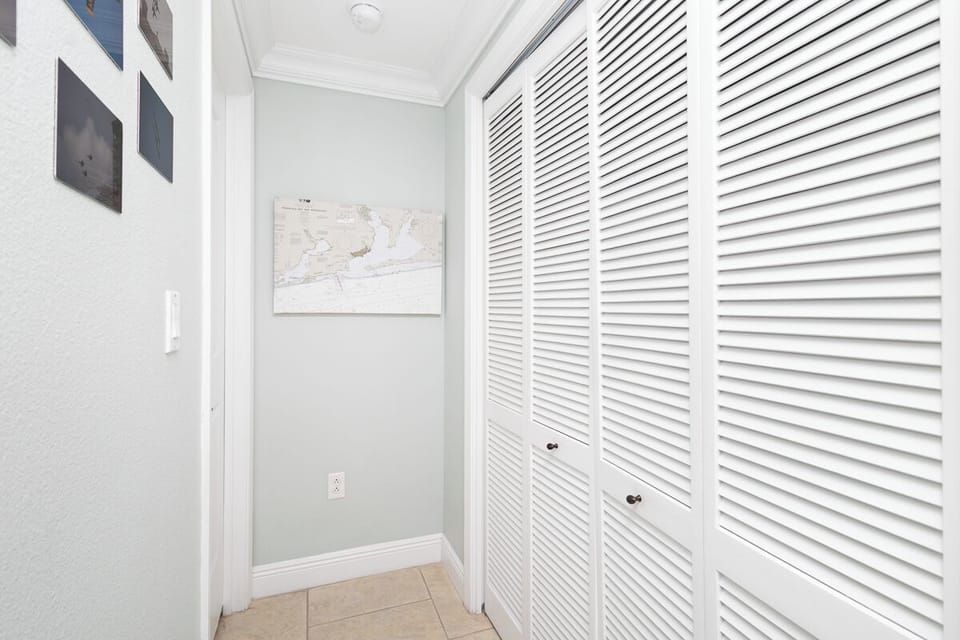 A bright hallway with generous built-in storage keeps your belongings organized and out of sight, making the space feel clean and uncluttered.
