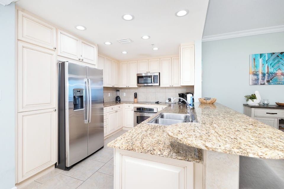 This bright, fully-equipped kitchen invites you to prepare meals with ease. Enjoy granite countertops, stainless steel appliances, and plenty of cabinet space for all your culinary adventures.