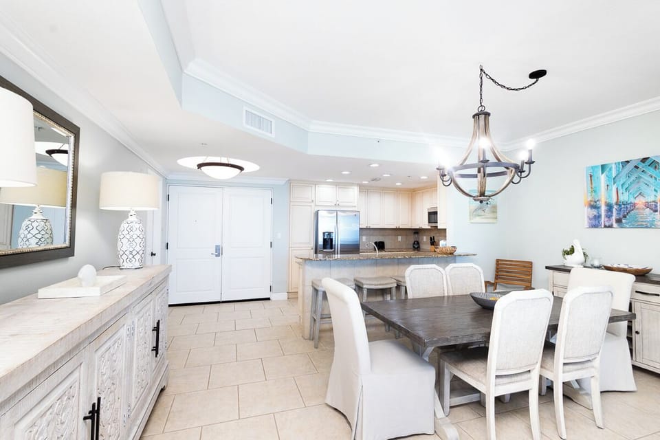 Step into a bright, open space where dining and cooking flow together effortlessly. Gather at the spacious table, whip up meals in your fully equipped kitchen, and enjoy coastal-chic touches throughout.