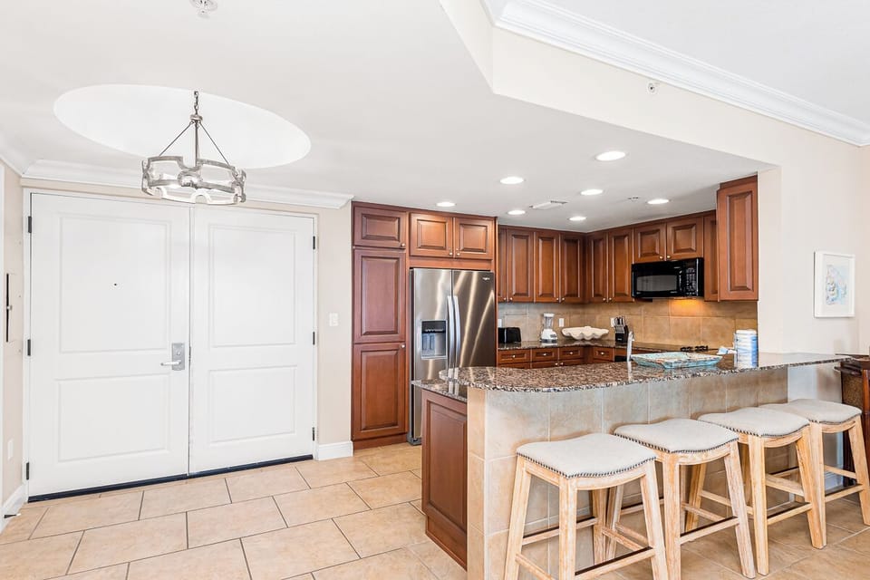 Your spacious kitchen features granite countertops, stainless steel appliances, and a breakfast bar where you can enjoy morning coffee.