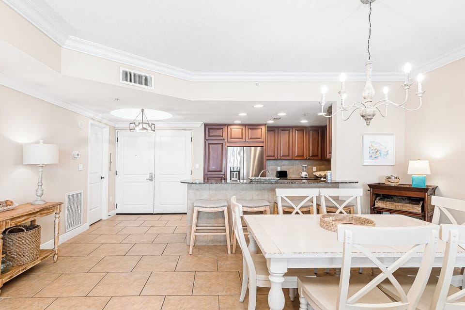 Step into your bright, open living space where coastal elegance meets modern comfort—perfect for gathering around the dining table after beach days.