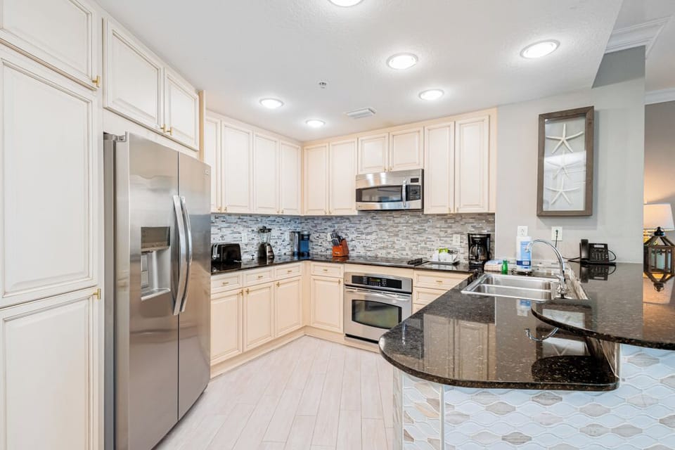 Your fully-equipped kitchen features sleek granite countertops, stainless steel appliances, and abundant cabinet space—perfect for preparing meals just the way you like them at home.