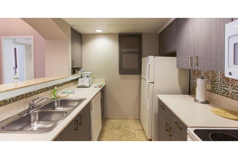 Kitchen, fridge, electric range, and dishwasher.