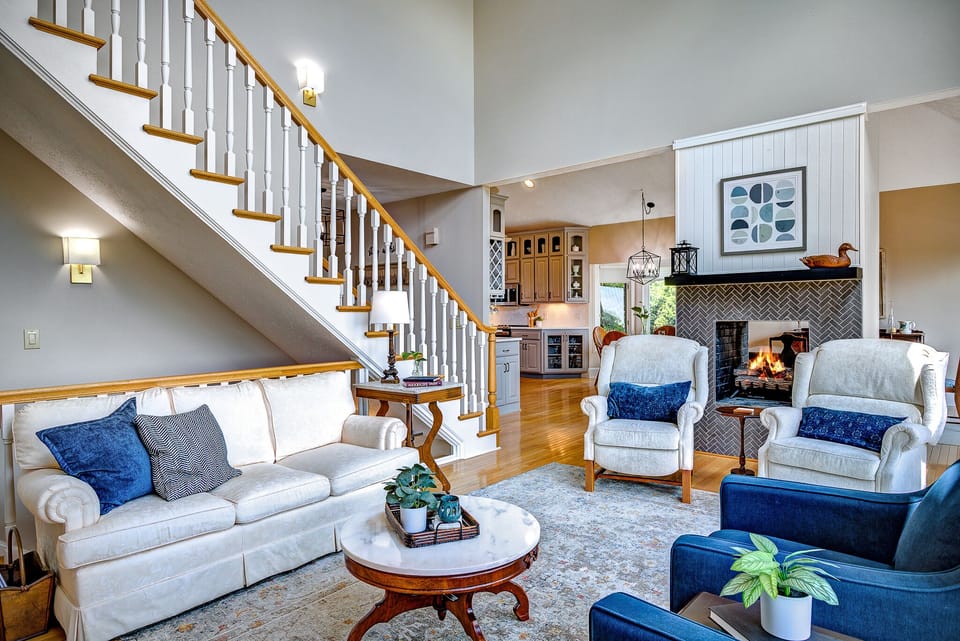 Living room with gas fireplace is open to kitchen and dining room. 