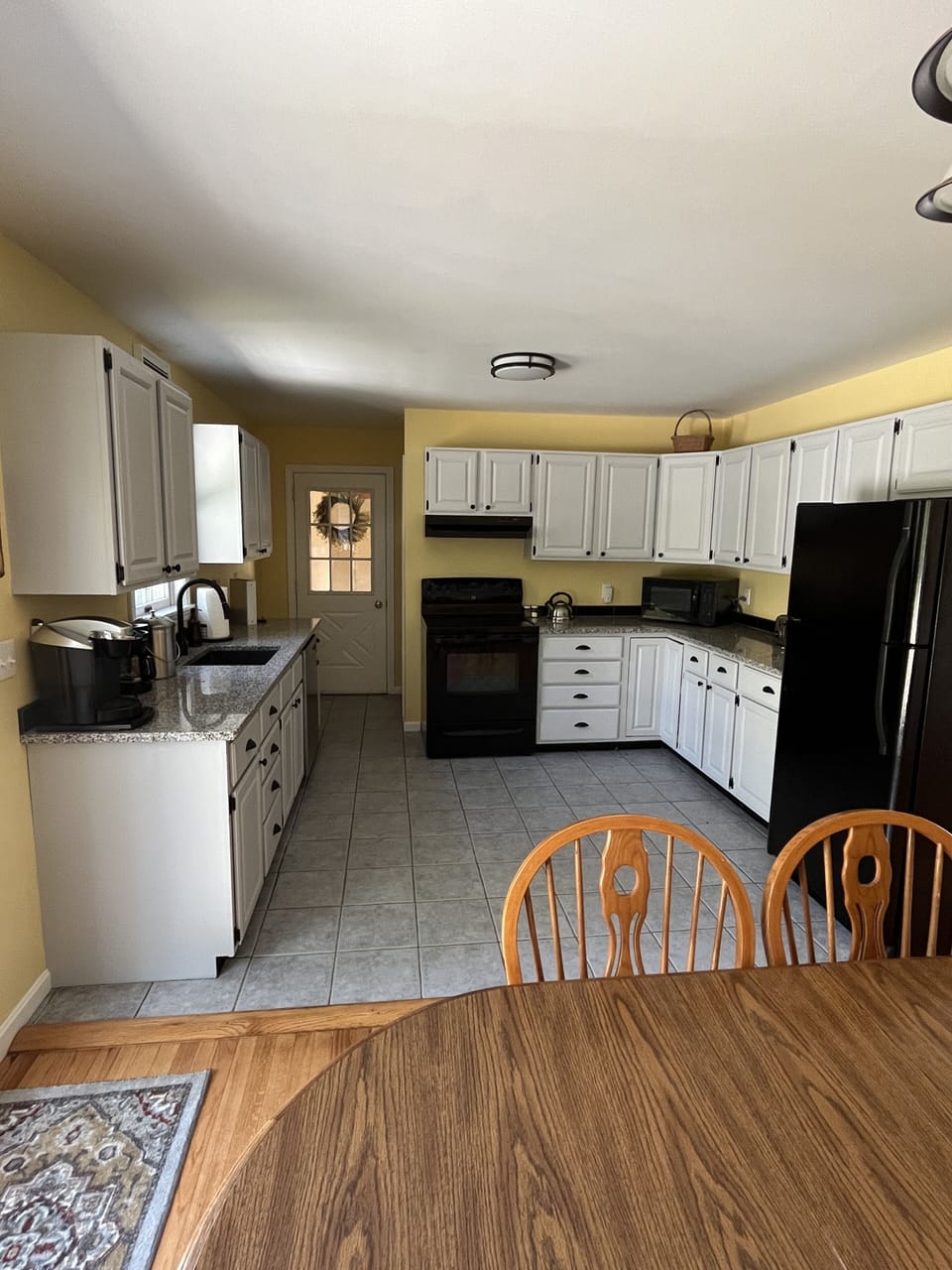 Dining area looking toward kitchen and garage door entry.