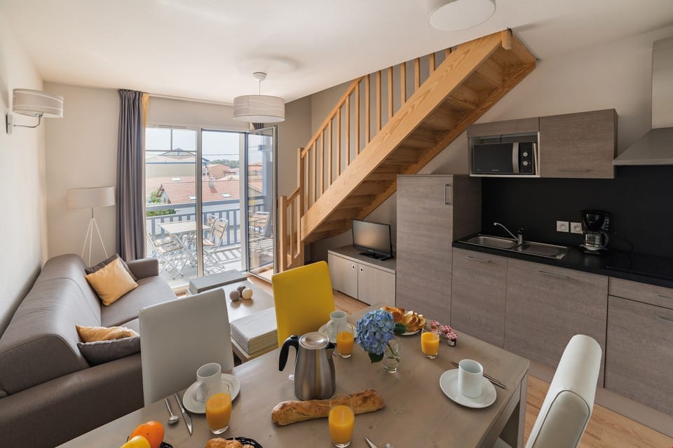 Modern kitchenette and bright living area. This unit may be available as a duplex!