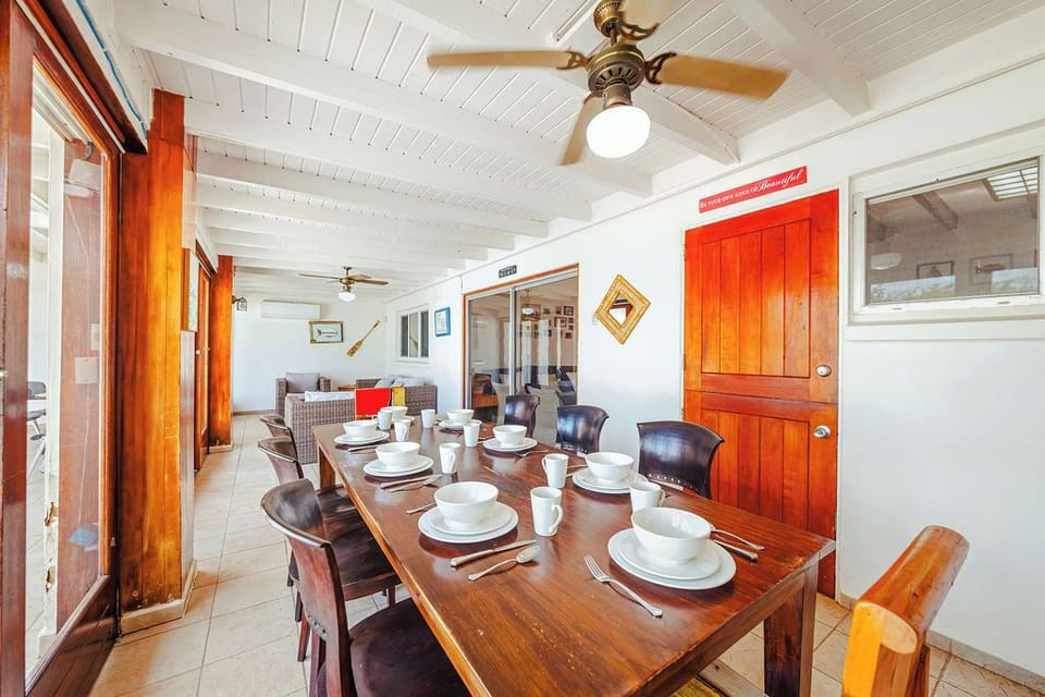 Our versatile common area is designed for connection. Enjoy a spacious family dinner at this large wooden table, and then seamlessly move into the adjacent living area for games or relaxation.