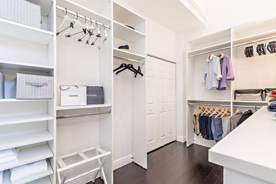 Master bedroom walk in closet with tons of storage and washer and dryer. 