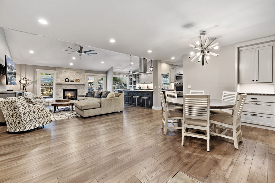 Our living room is complete with a plush sectional, cozy lounge chairs, 65" Smart TV and working fireplace.
