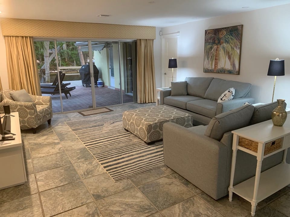 Large open family room with views of the pool and canal