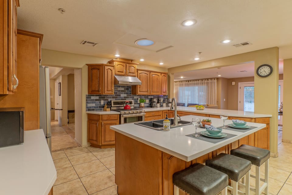Spacious, well stocked kitchen overlooks the great room and has both island seating and a breakfast bar.