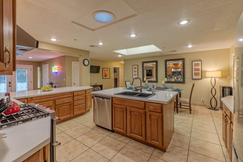 Kitchen transitions into a dining area with table seating.