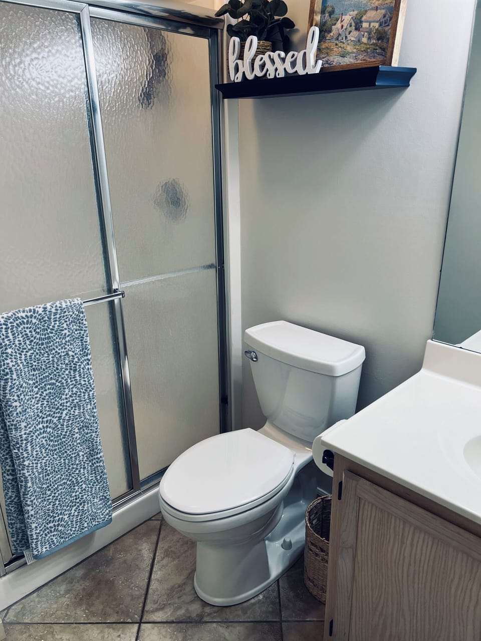 Main bath with full shower, sink and toilet.