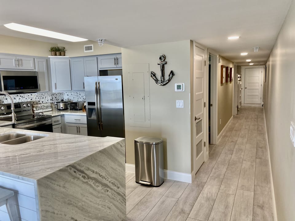 Looking toward both bedrooms, bunk beds and laundry closet. 