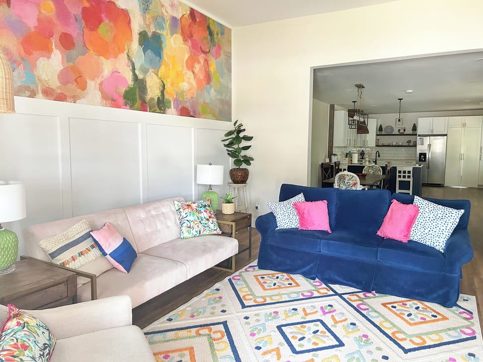 This spacious and vibrant living room will comfortably seat your group.