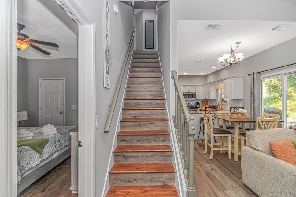 Stair case leading upstairs. Master bedroom on ground floor with full bathroom.