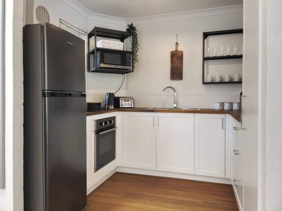 Kitchen fully equipped with full sized fridge  and microwave
