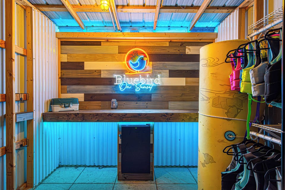 This beautifully built dock bar is stocked with a mini fridge to keep your cold drinks cold. Fishing supplies, life jackets and lily pad are also be found in here