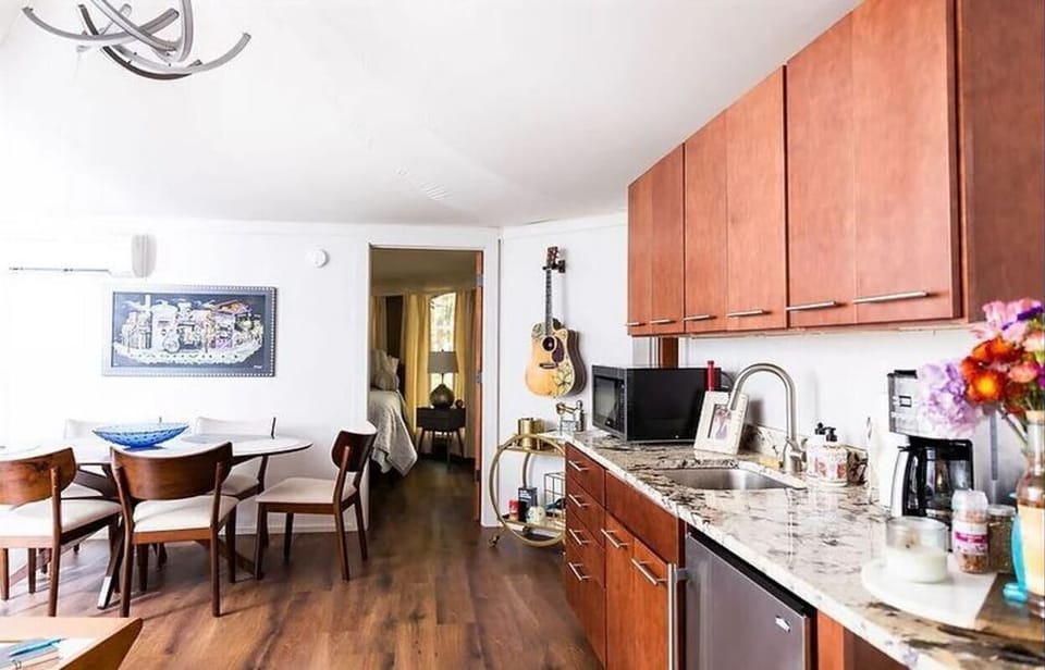 the Music Loft Kitchenette features a fridge, microwave & dishes & utensils. 