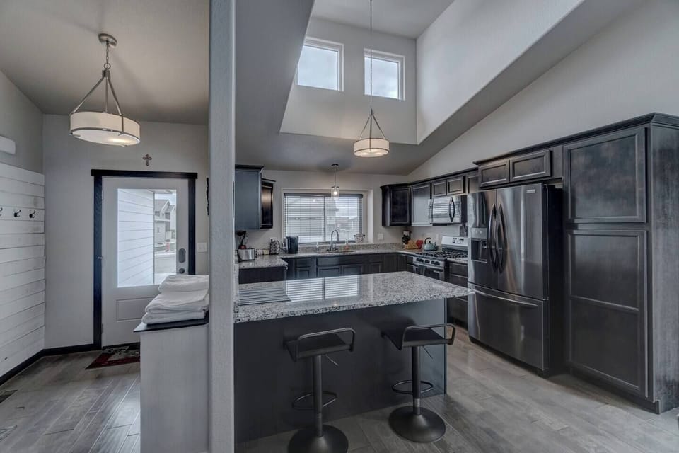 Kitchen with stainless steel appliances and granite countertops.

Keurig coffee maker and many other cooking and baking utensils along with food processor.