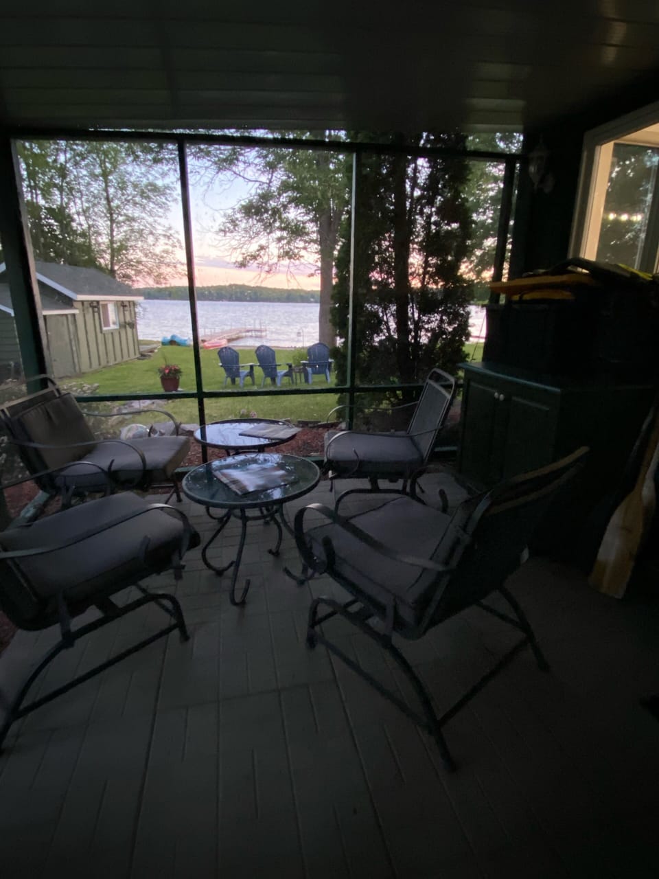 Screened in porch with cushioned chairs with perfect view of the sunset! 