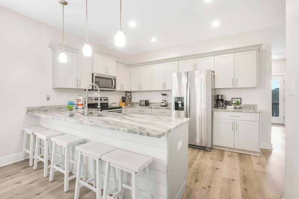 Fully stocked kitchen with a spacious breakfast bar.