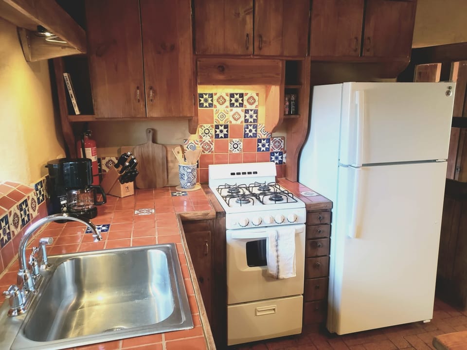 Full kitchen with custom cabinets and hand painted Talavera tile