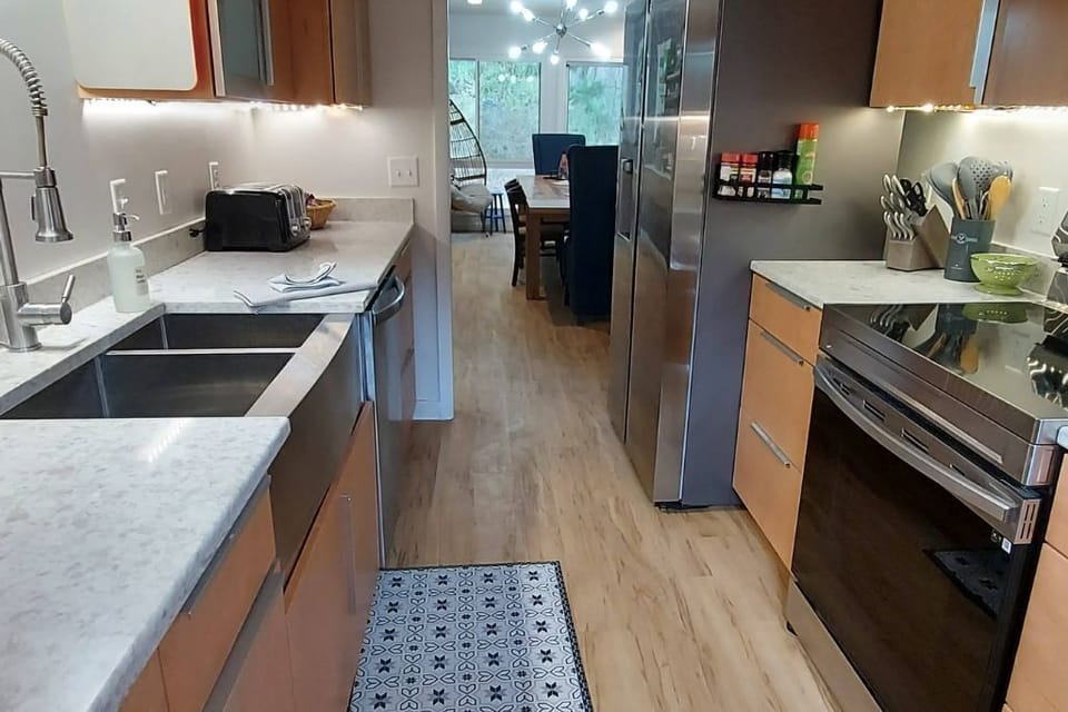 The kitchen has access to the indoor - and outdoor, dining areas