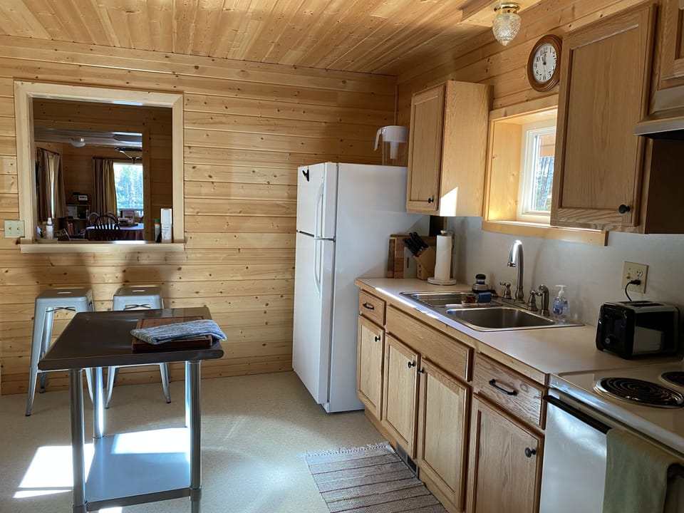 Looking from kitchen through entry to main room and lake views