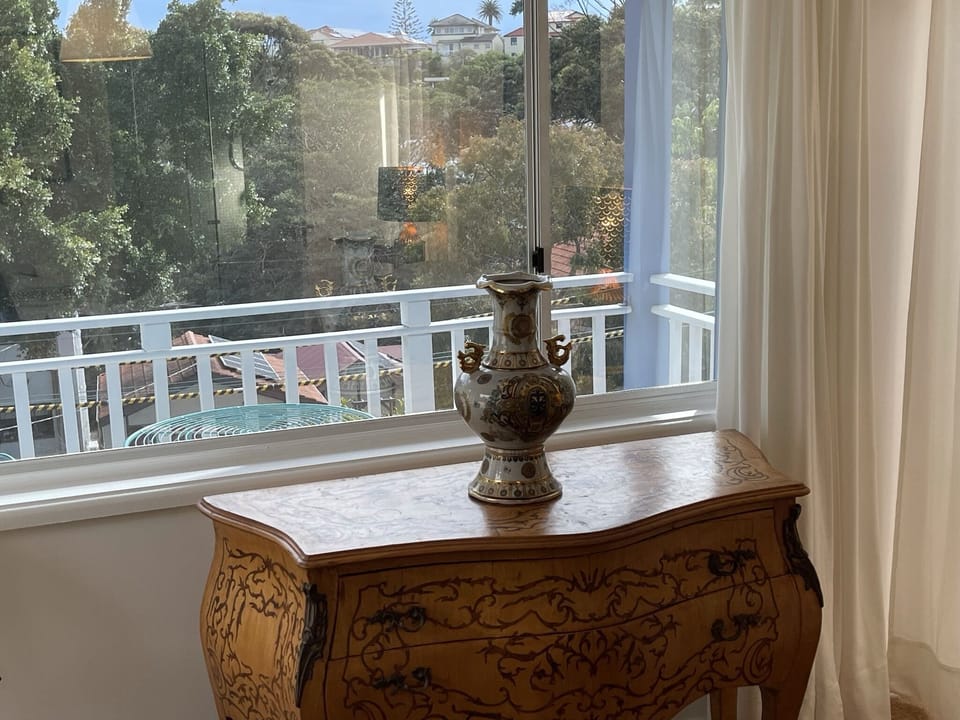 View through master bedroom of verdant neighbourhood