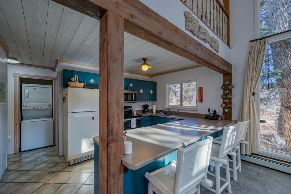 Fully-appointed kitchen with bar seating.
