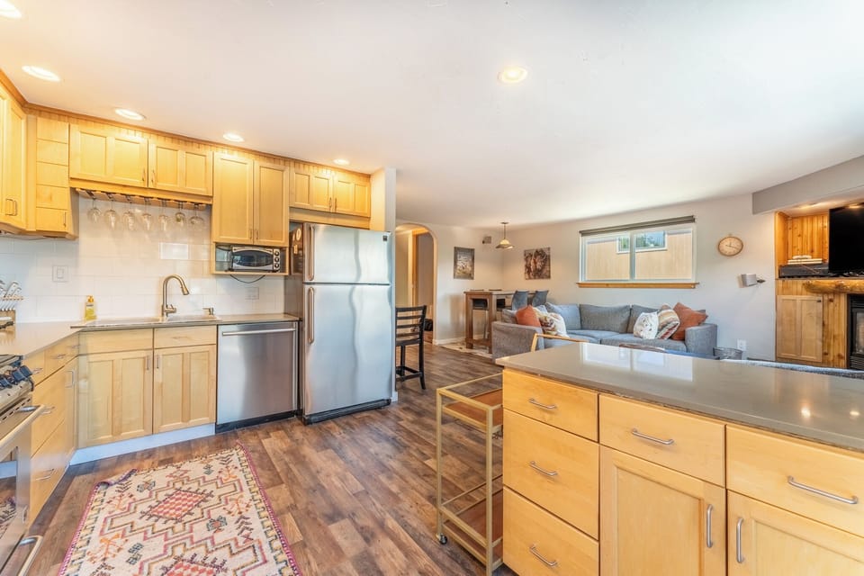 Full size kitchen with stainless steel appliances and granite countertops.