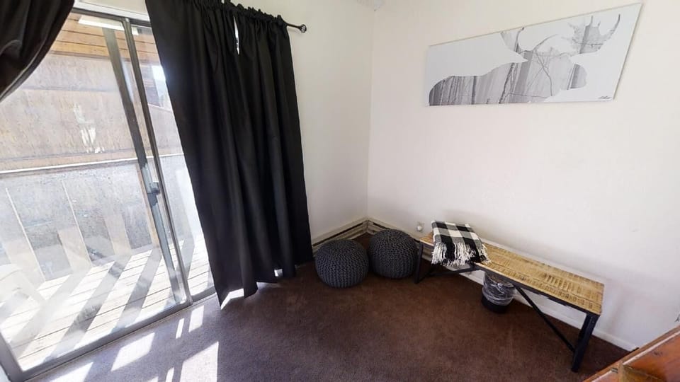 A serene space bathed in natural light, featuring minimalist décor and rustic wood touches. Your peaceful corner to unwind and enjoy the view.
