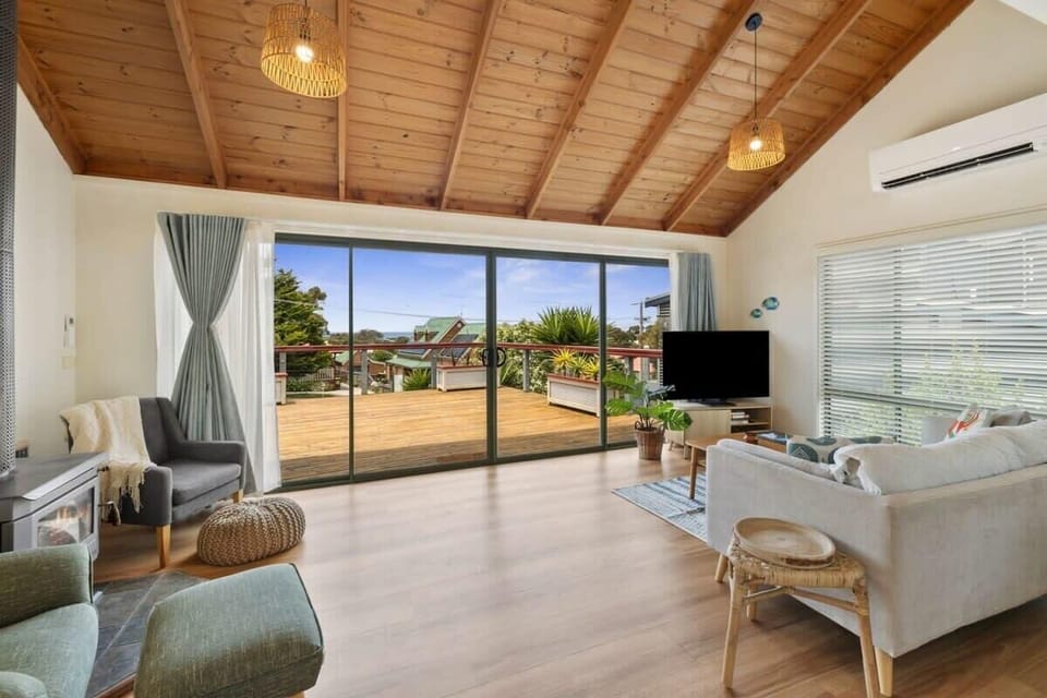 The cosy fireplace and inviting interiors make this beach house feel like a home away from home