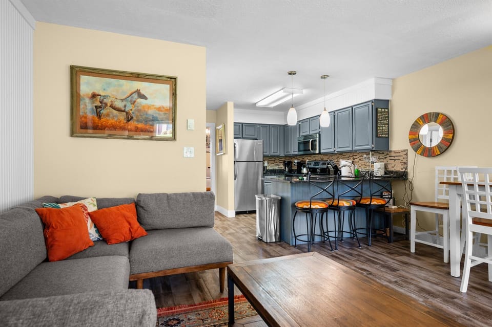 Open-concept living room connecting to kitchen and dining — ideal for groups.