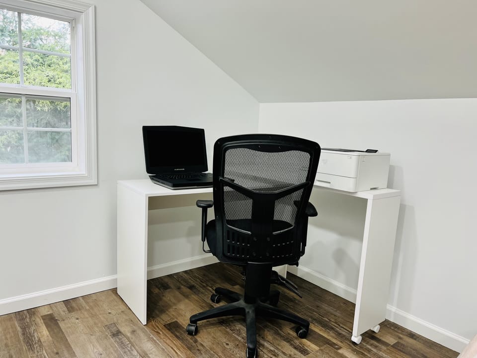 Work desk with a laptop and printer.
