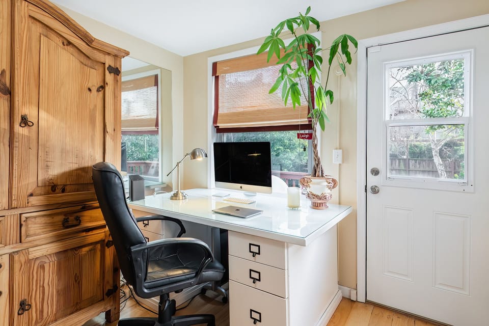 Large desk area with in unit washer and dryer on the other side of this room. 
