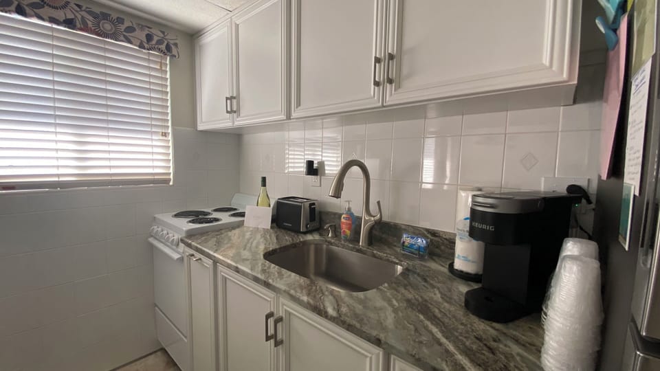 Kitchen stocked with dishes, utensils, pots and pans.