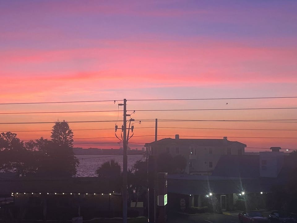 Magenta sunrise over bay balcony