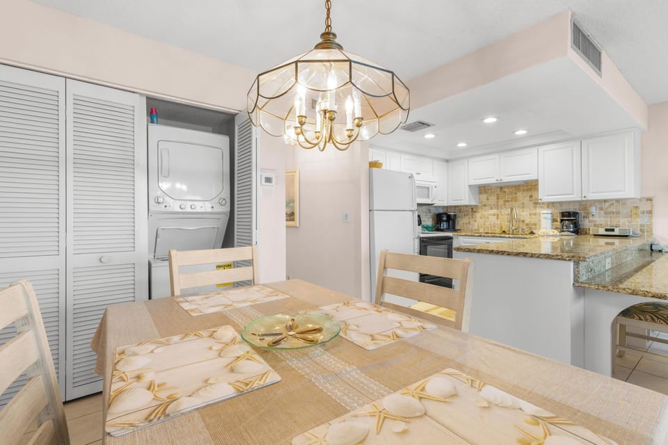 Dining Table. Washer/Dryer in Unit # 507,is located behind folding louvered doors