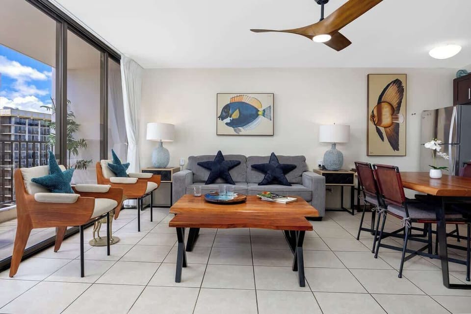 Enjoy comfortable seating, unique tropical art, and bright natural light right off the balcony.