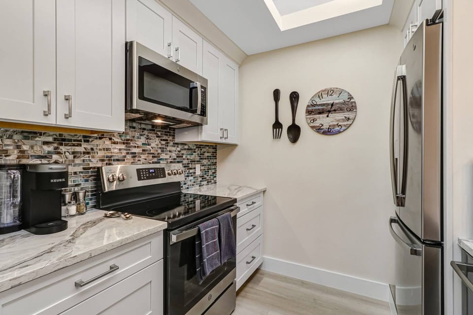 The kitchen offers full size appliances, quartz counters, and is filled with the items needed to prepare meals during your stay.