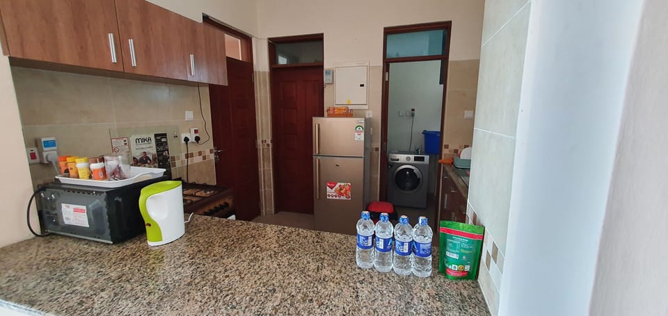 Open and fully fitted kitchen w/ access to laundry equipped with washing machine