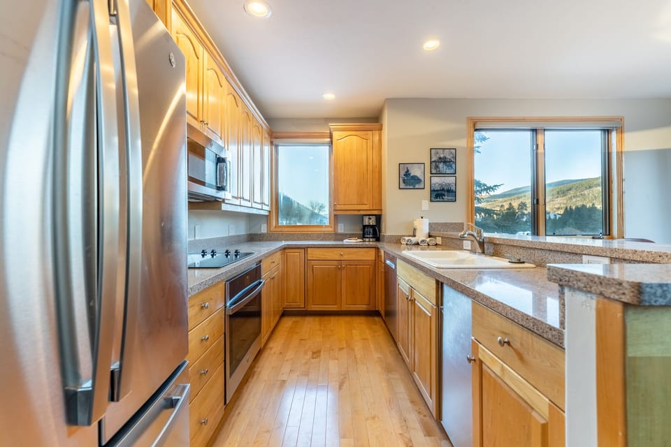 Your fully equipped kitchen features granite counters, stainless appliances, and inspiring mountain views while you cook.