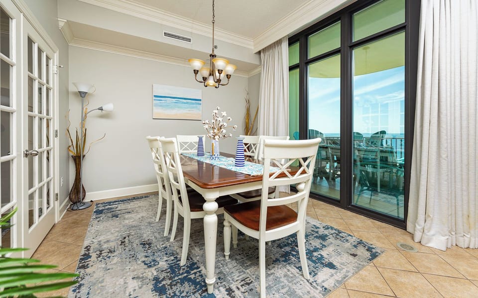 Your dining room invites laughter and delicious family meals with bright sunlight from the balcony
