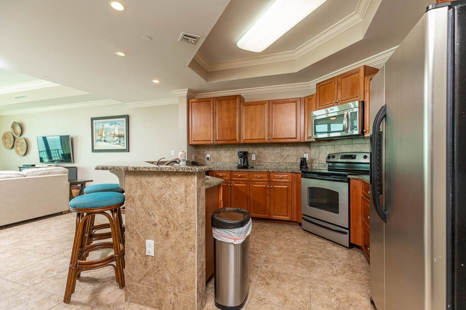 Prepare meals in this kitchen with elegant cabinetry, stainless appliances, and spacious countertops