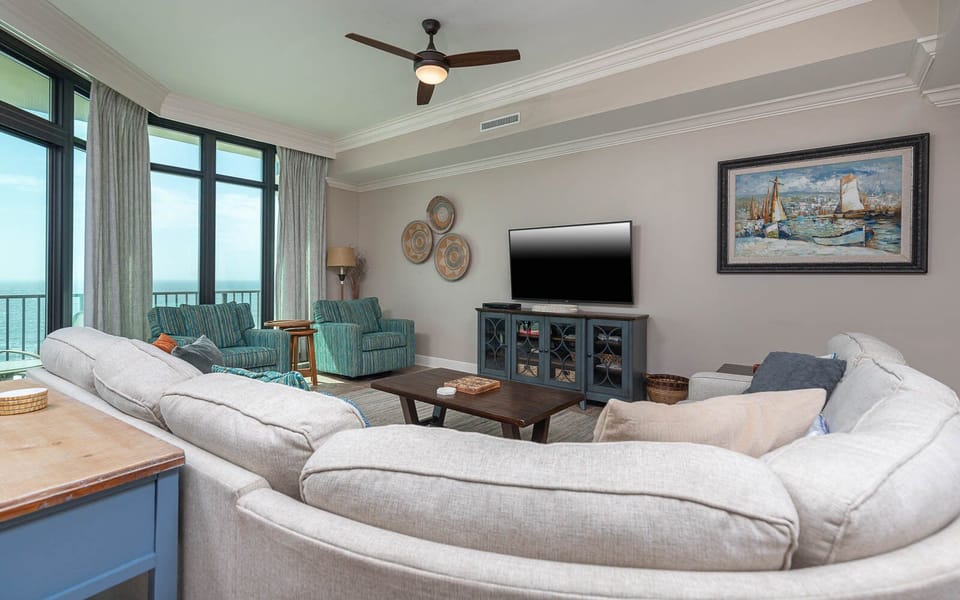 Unwind in the living area, featuring a queen sofa sleeper, enjoying coastal views from the balcony